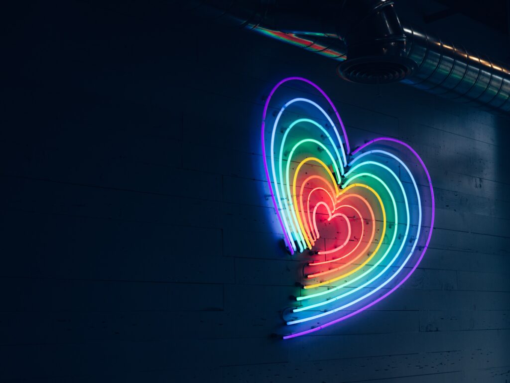Neon Pride Heart on a dark wall